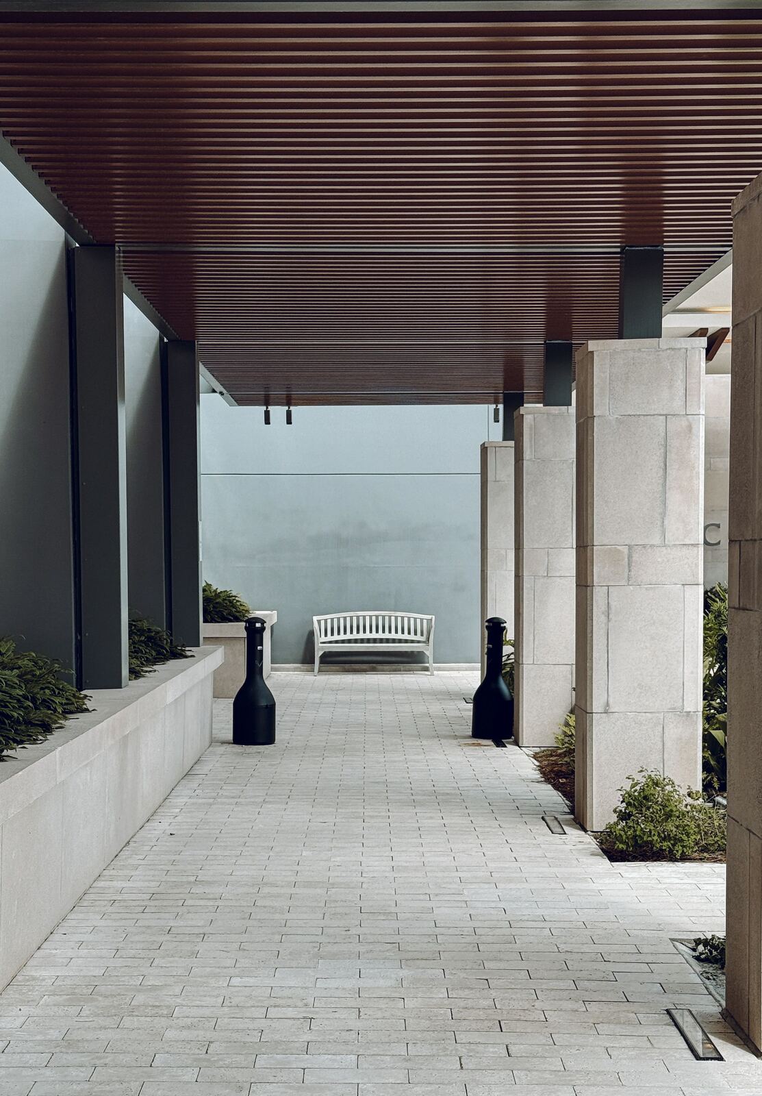 Paver walkway leading to a covered entry